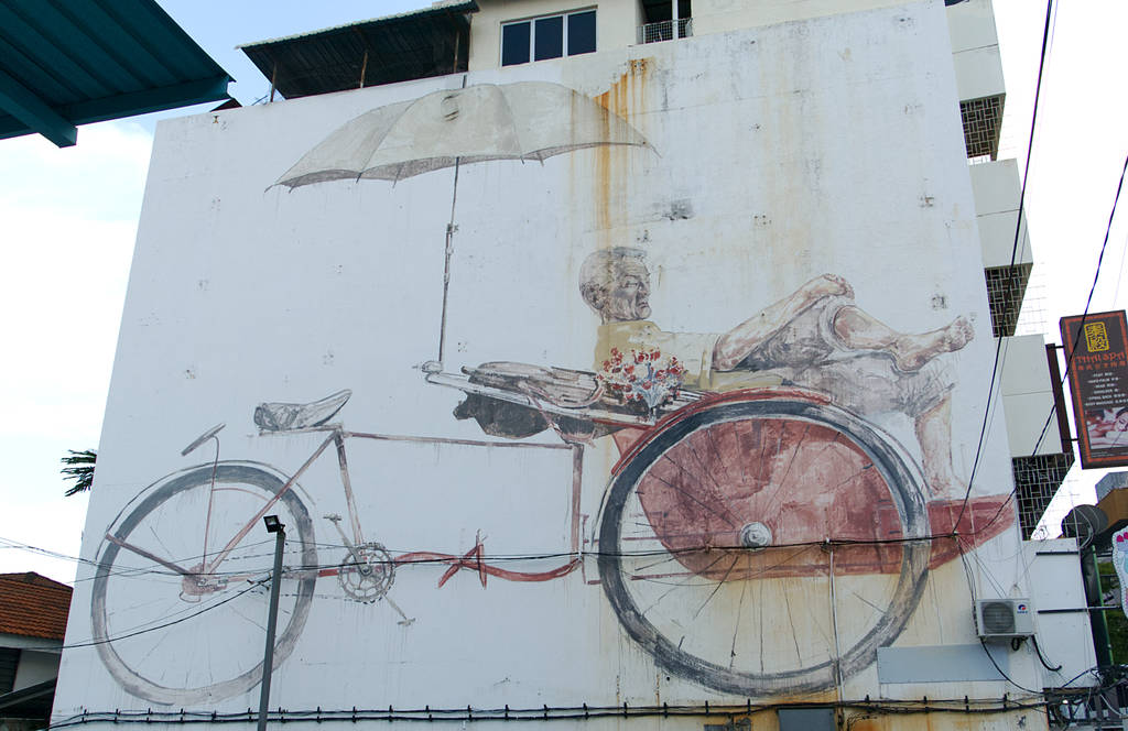 Street Art Mann in Rikscha